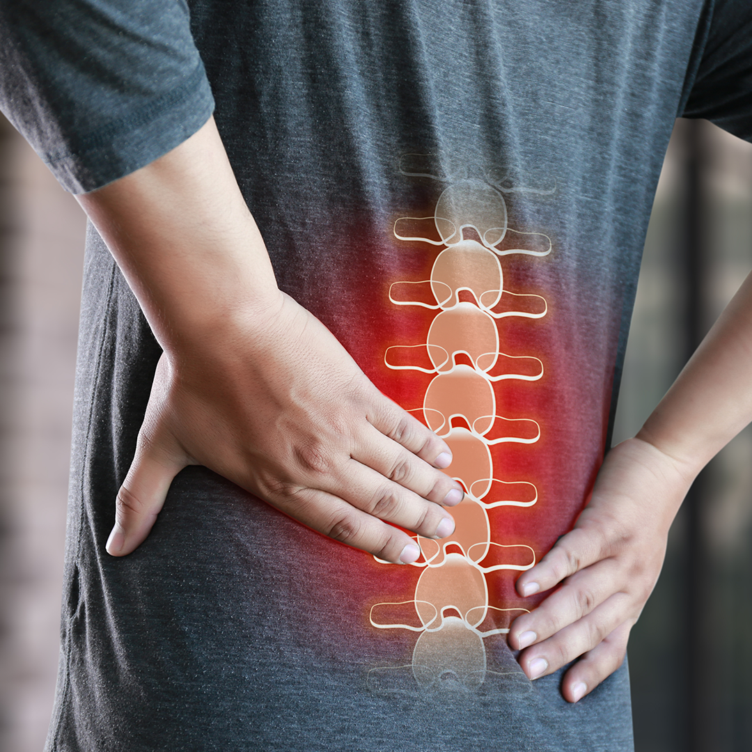 man holding his lower back due to disc pain