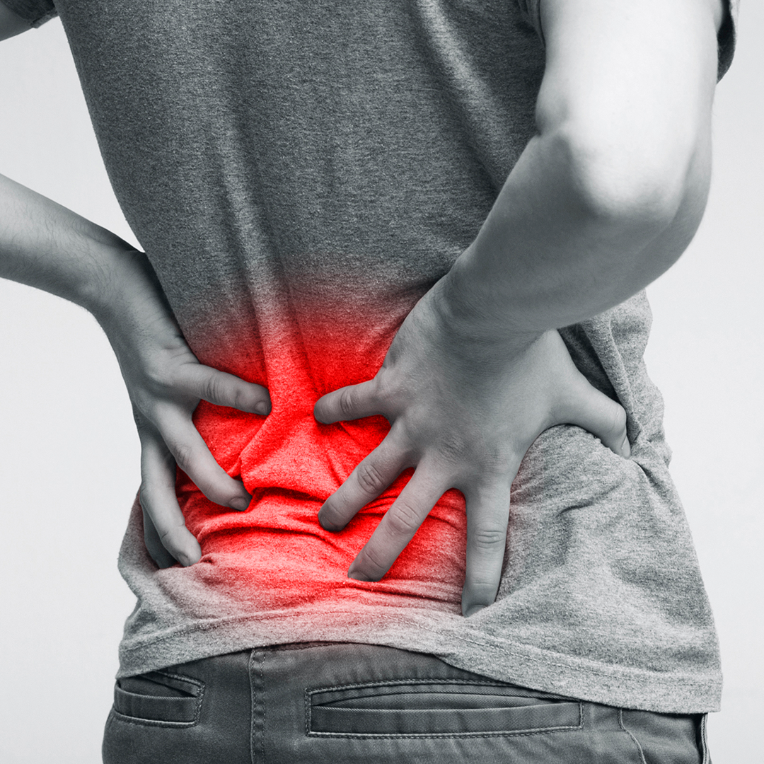 man holding his lower back due to pain