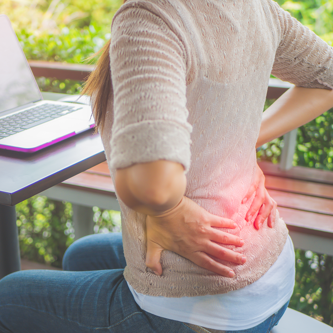woman working sitting in front of laptop suffer disc pain